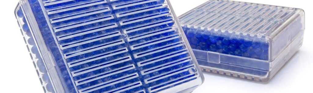 Blue indicating silica gel in clear plastic containers.