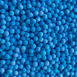 A close up of beaded, blue indicating bulk molecular sieve desiccant.